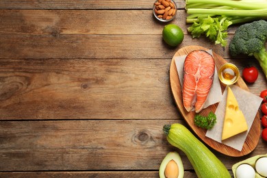 Different products on wooden table, flat lay with space for text. Keto diet