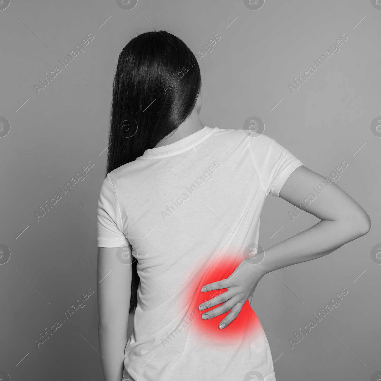 Image of Woman suffering from rheumatism on light background. Black and white effect with red accent in painful area