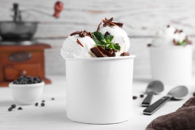 Yummy ice cream with chocolate served on white table