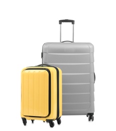 New suitcases packed for journey on white background