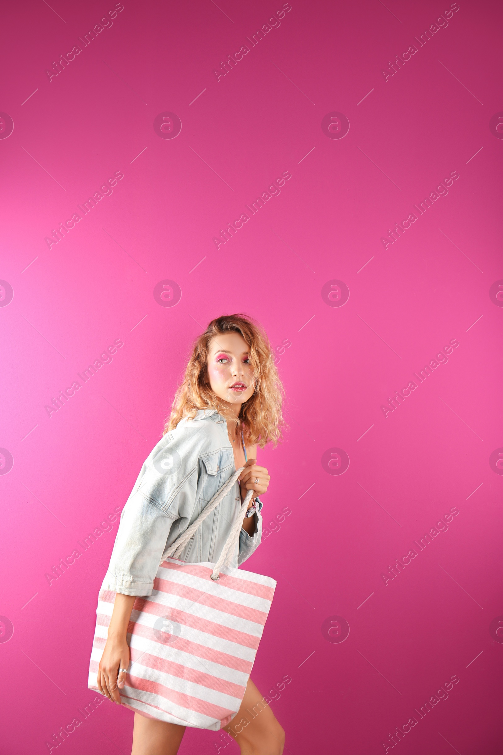 Photo of Beautiful young woman posing on color background. Summer fashion