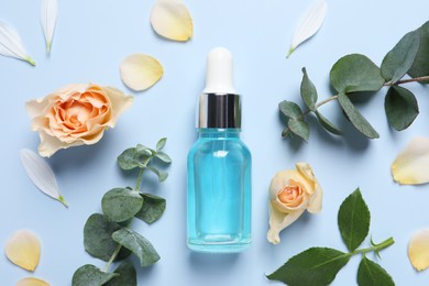 Photo of Flat lay composition with cosmetic serum on light blue background