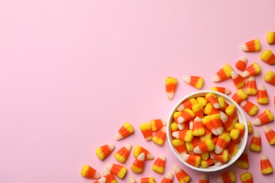 Photo of Colorful candy corns and space for text on color background, top view