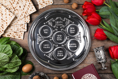 Photo of Flat lay composition with Passover Seder plate (keara) on wooden table. Pesah celebration