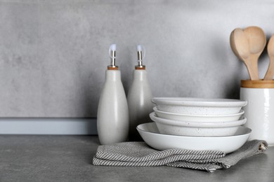 Photo of Set of different cooking utensils on grey countertop in kitchen. Space for text