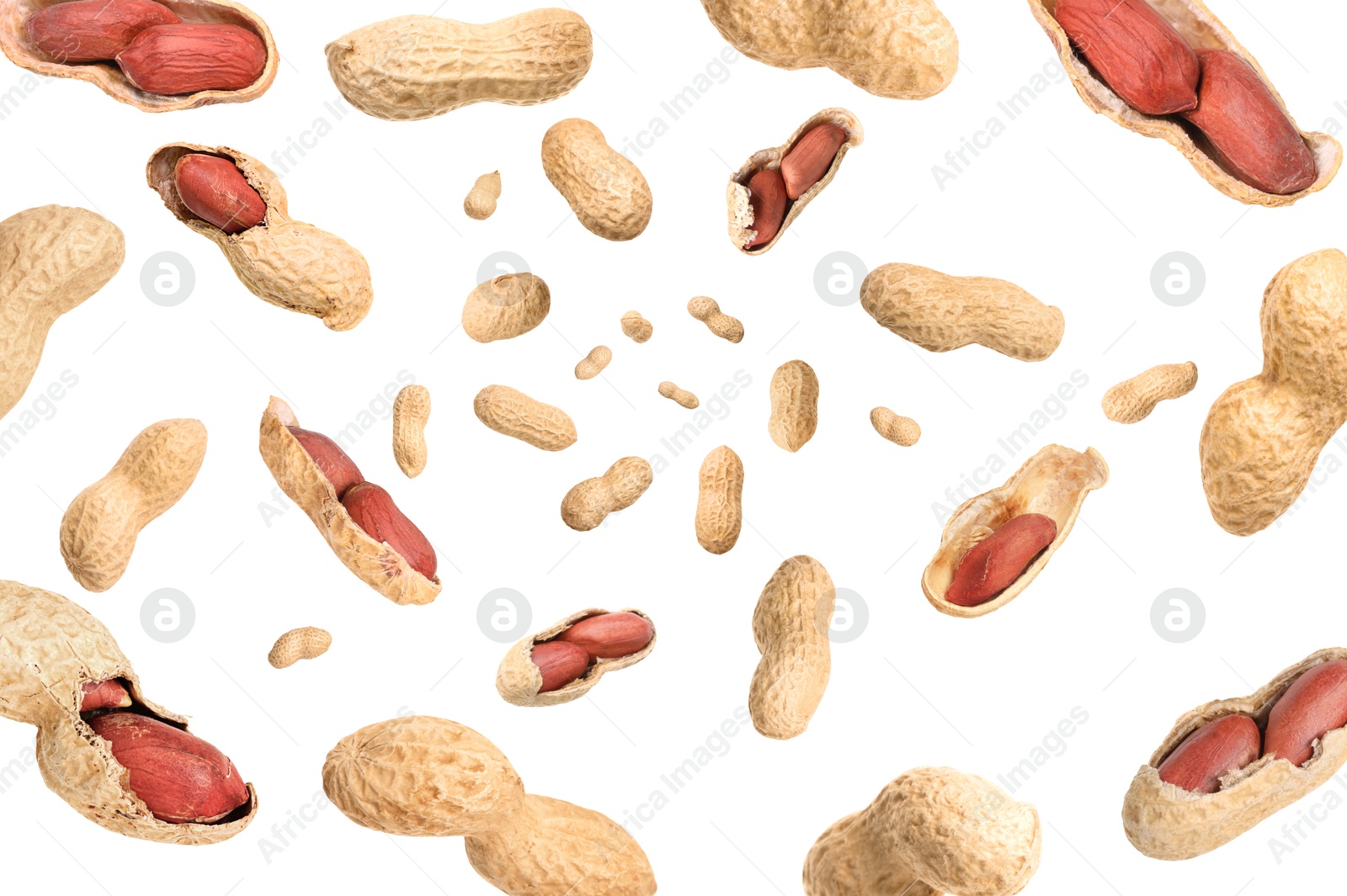 Image of Unpeeled peanuts in air on white background