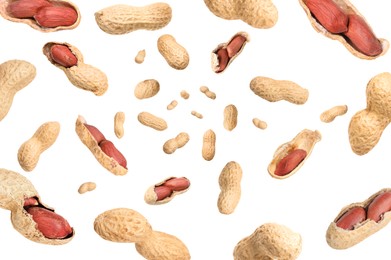 Image of Unpeeled peanuts in air on white background