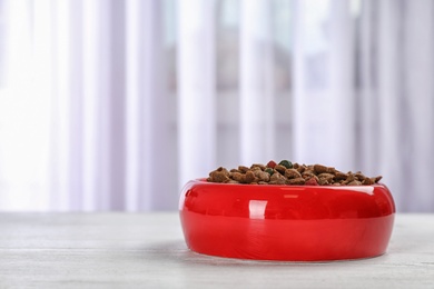 Bowl with food for cat or dog on floor. Pet care