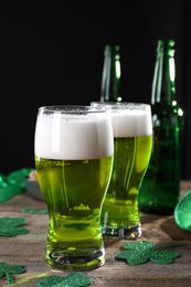 St. Patrick's day party. Green beer and decorative clover leaves on wooden table