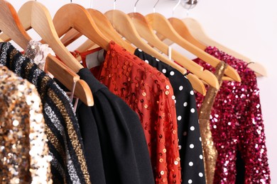 Photo of Collection of different beautiful women's party dresses on hangers in showroom. Stylish trendy clothes for high school prom