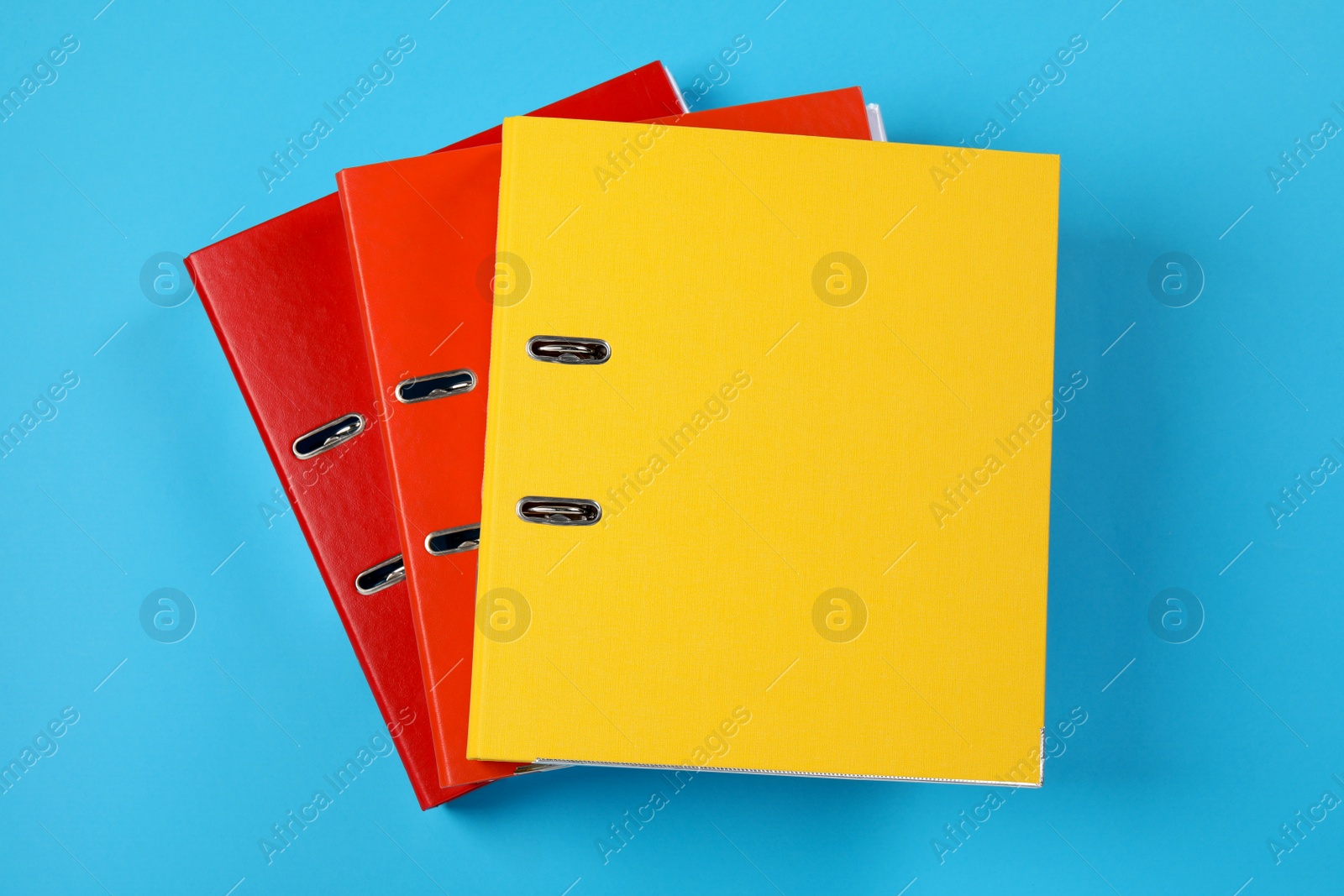 Photo of Many office folders on light blue background, flat lay