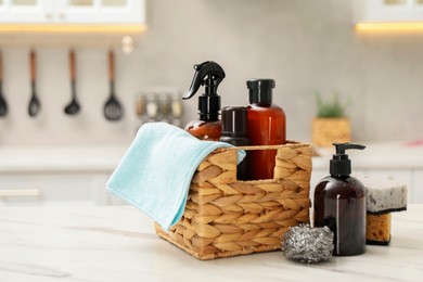 Different cleaning supplies in basket on table