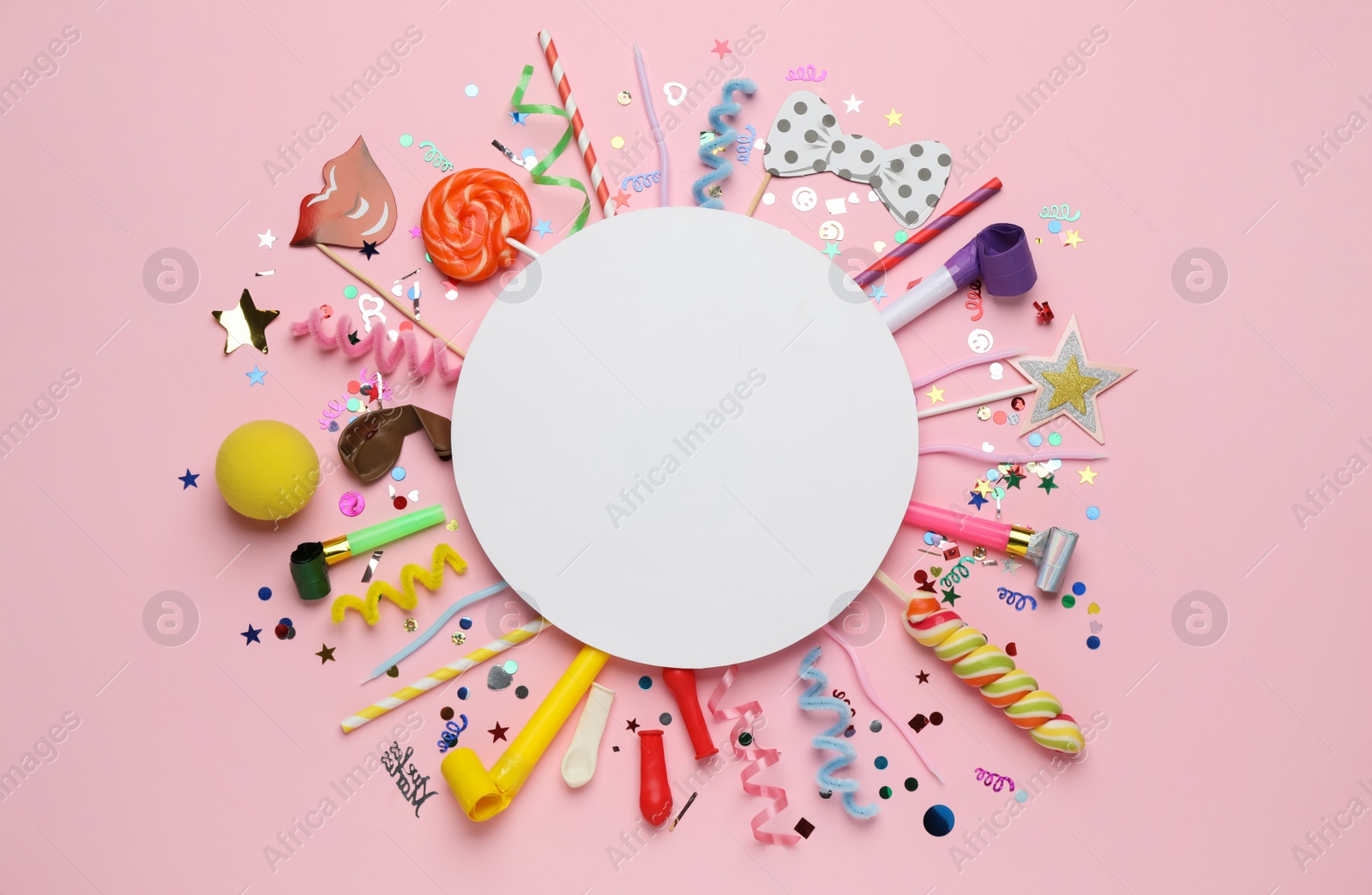 Photo of Flat lay composition with blank card and different party accessories on pink background, space for text. Birthday surprise