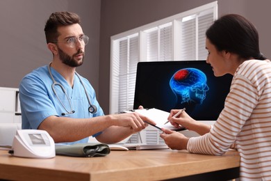 Photo of Young woman filling form in neurologist office