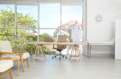 Modern medical office interior with doctor's workplace near window