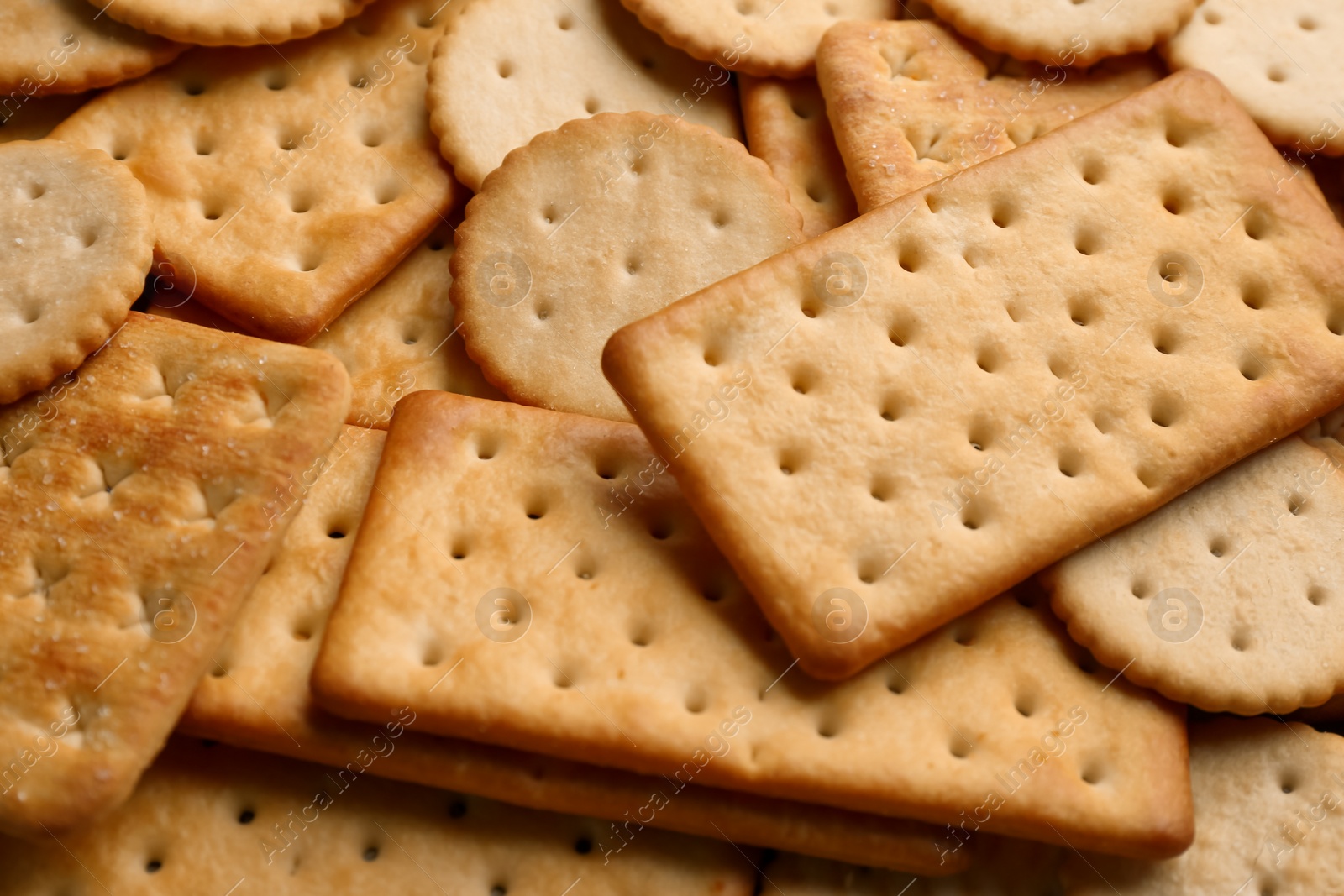 Photo of Many delicious crackers as background, closeup view