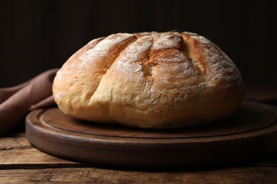 Photo of Loaf of tasty wheat sodawater bread on wooden table