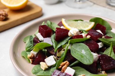 Delicious beet salad served on table, closeup