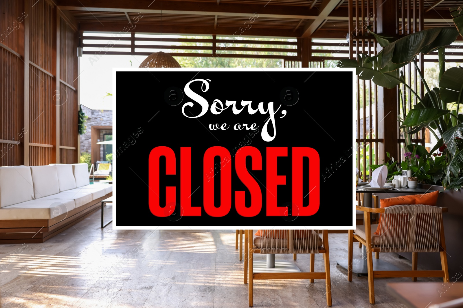 Image of Sorry we are closed sign. Cozy cafe with stylish furniture