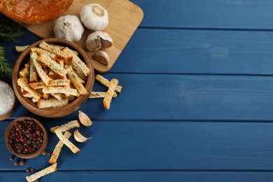 Delicious hard chucks and garlic on blue wooden table, flat lay. Space for text