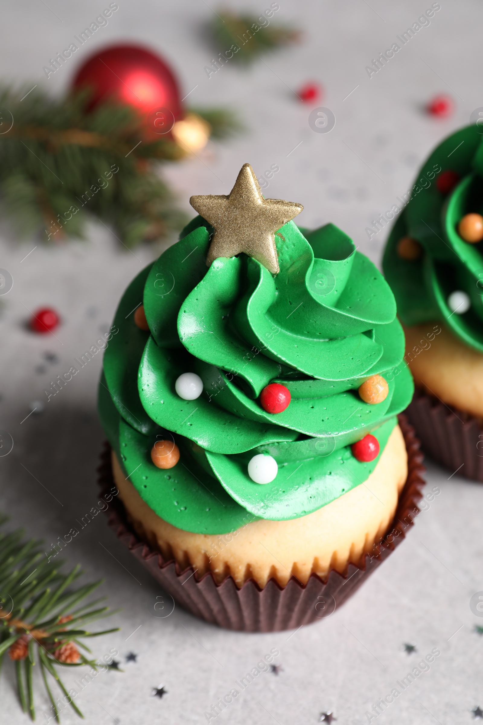 Photo of Christmas tree shaped cupcakes on light grey table