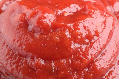 Photo of Tasty ketchup as background, closeup. Tomato sauce