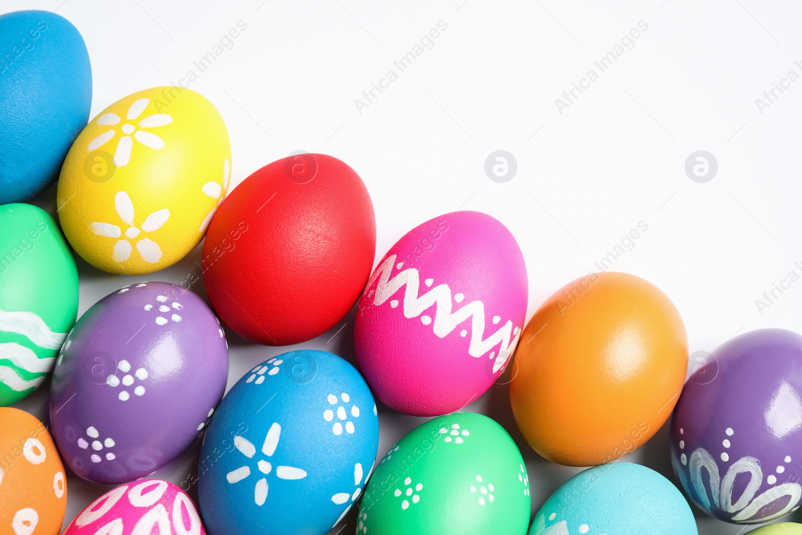 Photo of Colorful Easter eggs with different patterns isolated on white, top view