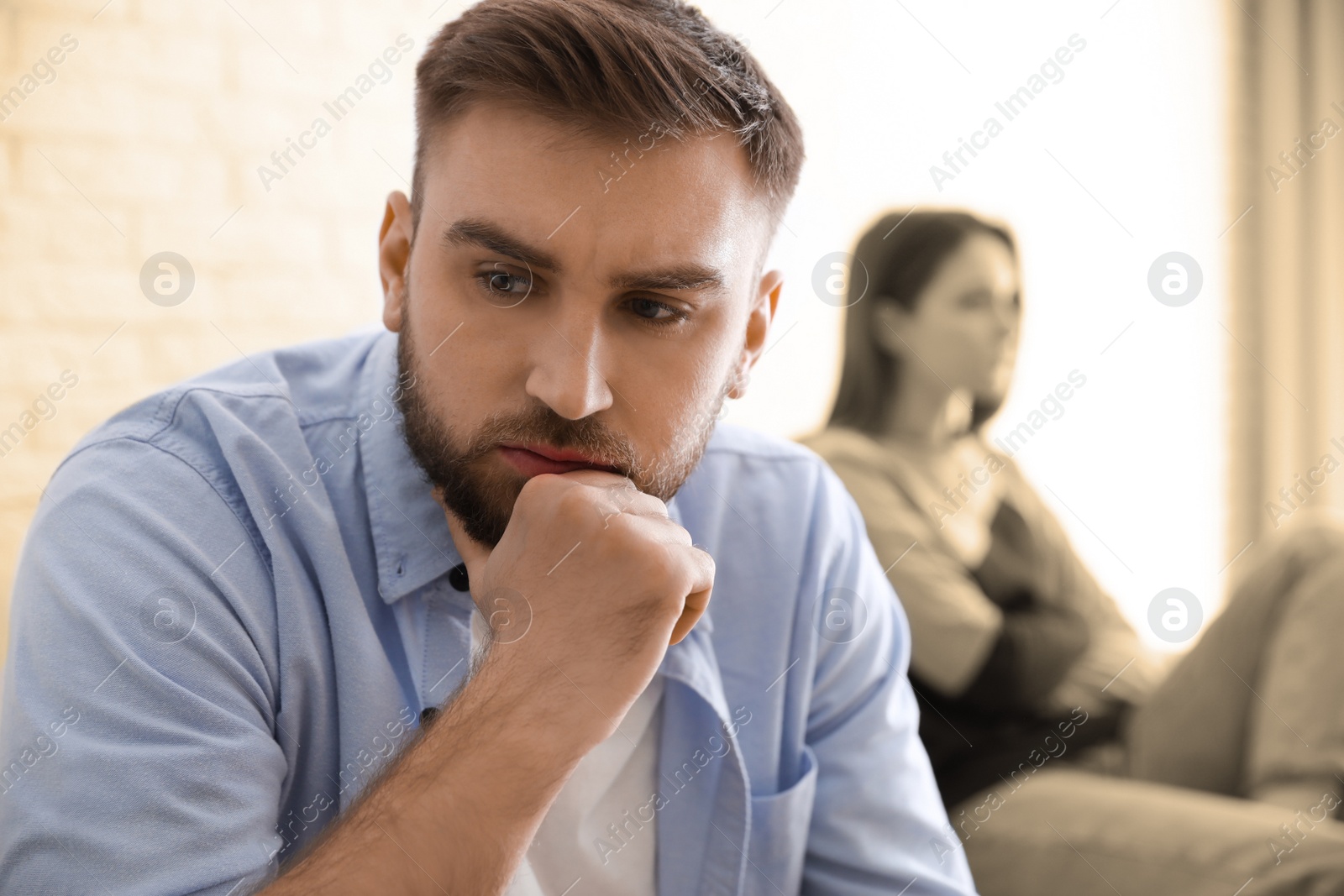 Image of Unhappy young couple with relationship problems at home, focus on man. Cheating and breakup