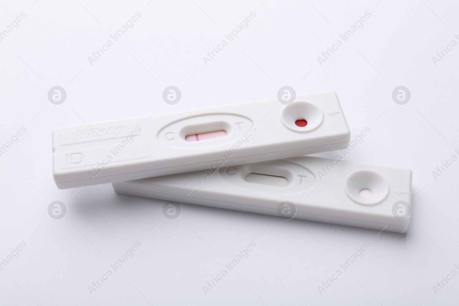 Photo of Two disposable express tests on white background