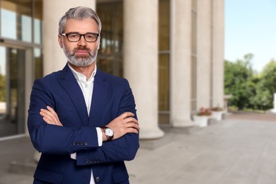 Image of Successful lawyer near building outdoors, space for text