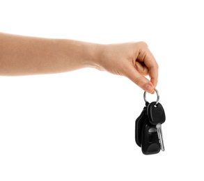 Woman holding key on white background, closeup. Car buying
