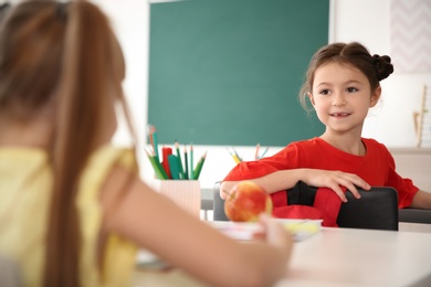 Photo of Cute little children in classroom. Elementary school