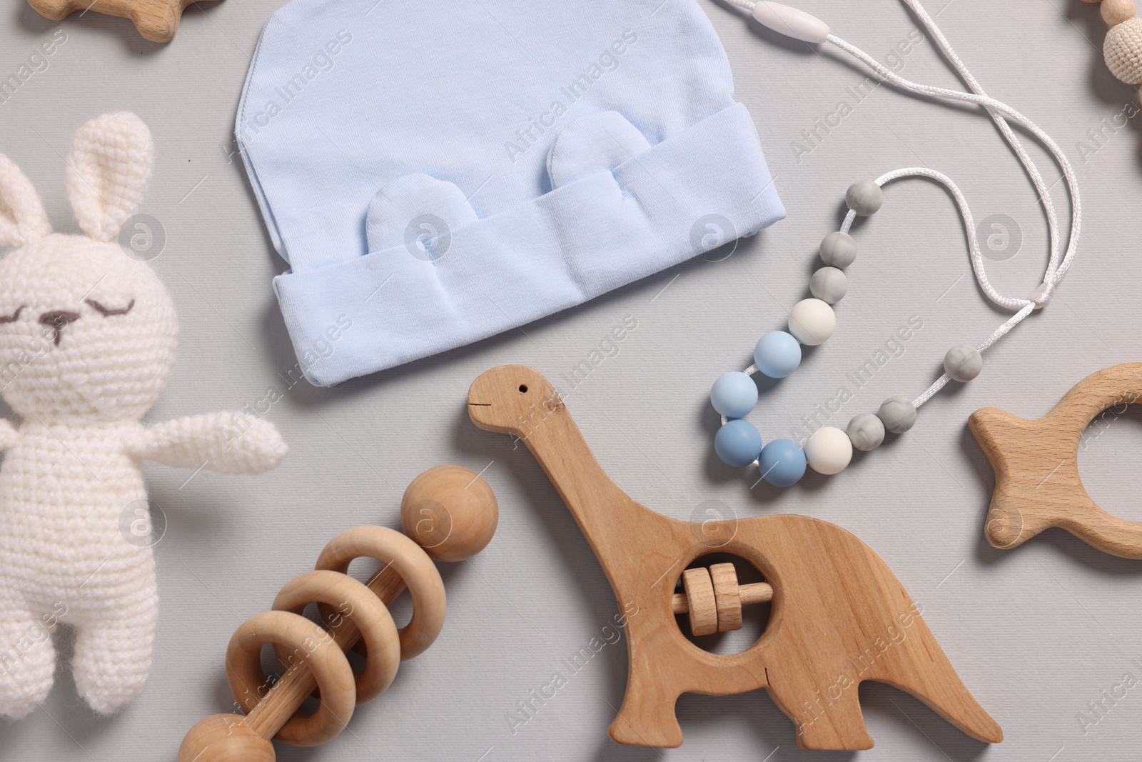 Photo of Different baby accessories on grey background, flat lay