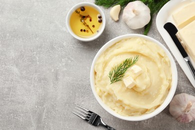 Photo of Delicious mashed potato with dill and butter served on light grey table, flat lay. Space for text