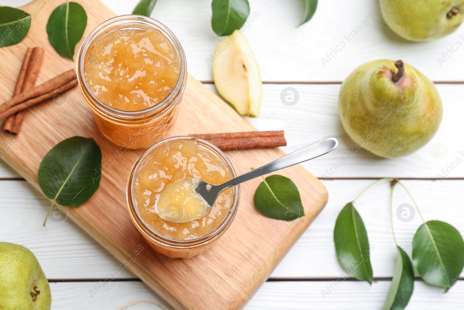 Photo of Delicious pear jam and fresh fruits on white wooden table, flat lay