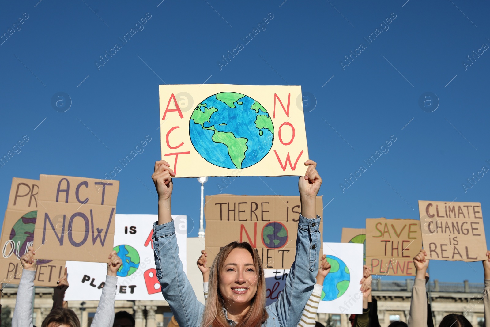 Photo of Group of people with posters protesting against climate change outdoors