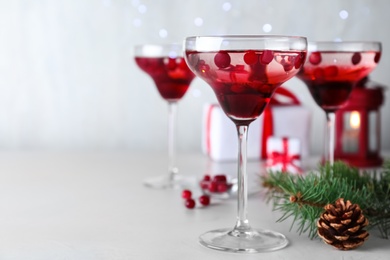 Photo of Delicious Christmas cocktail with liqueur on white table. Space for text