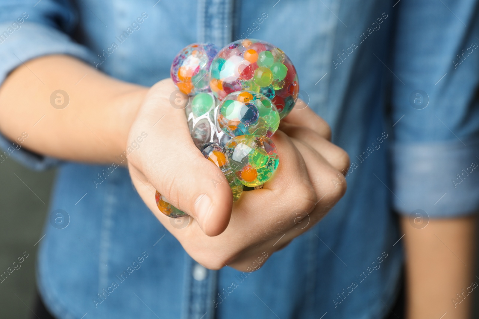 Photo of Woman squeezing colorful slime, closeup. Antistress toy