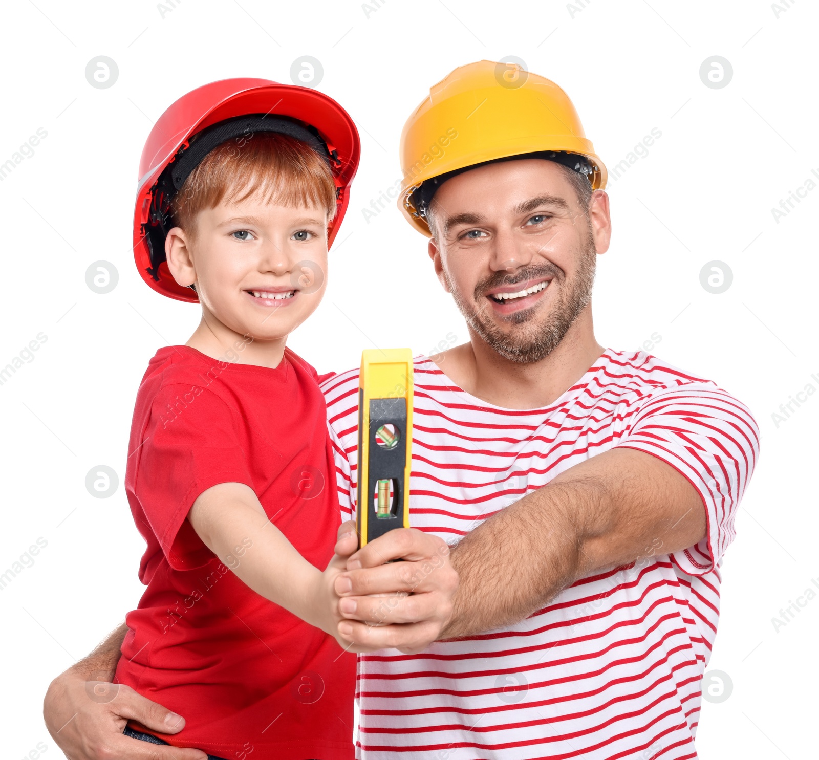Photo of Father and son in hard hats holding bubble level on white background. Repair work