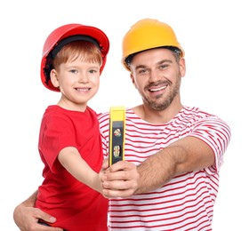 Photo of Father and son in hard hats holding bubble level on white background. Repair work