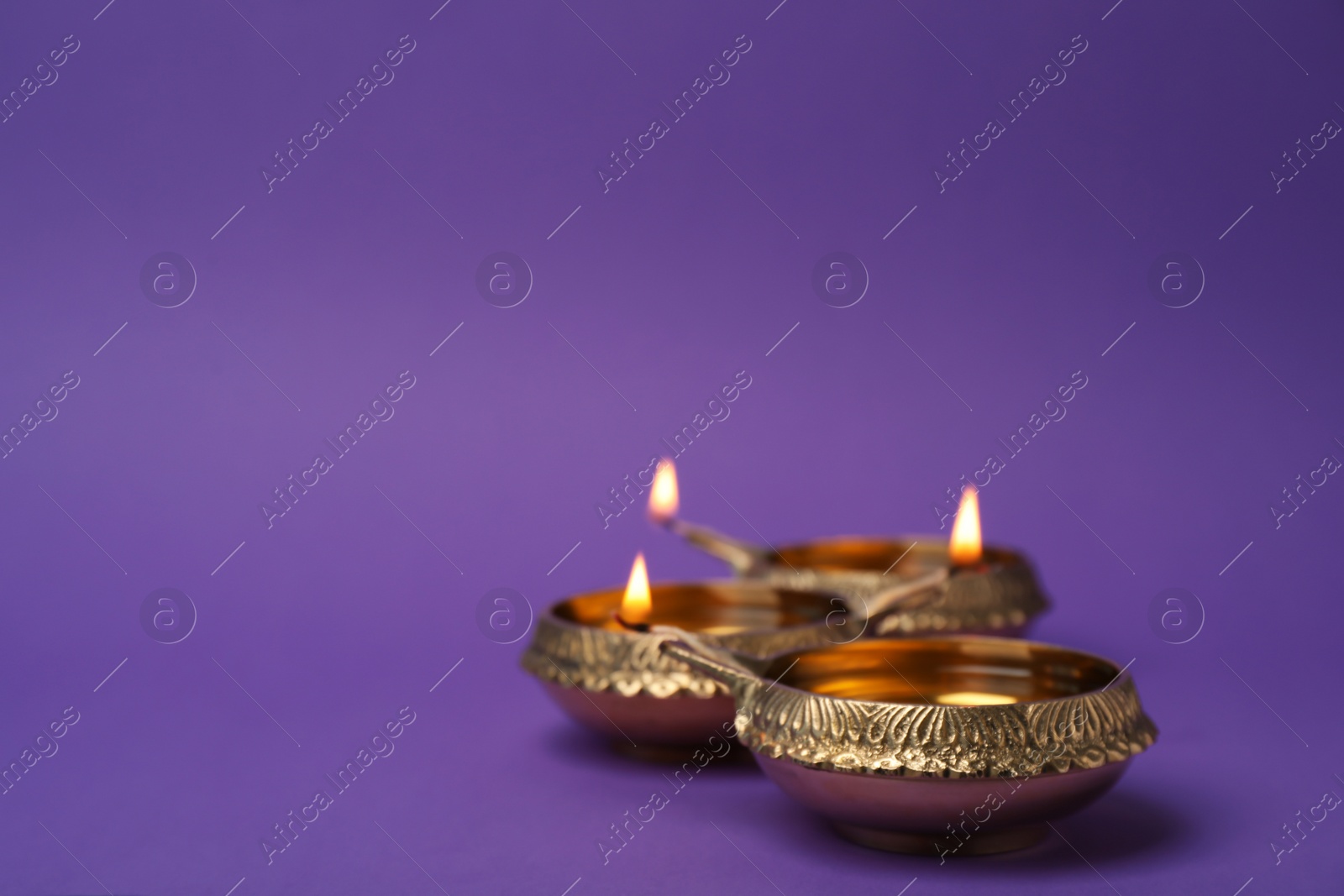 Photo of Diwali diyas or clay lamps on color background