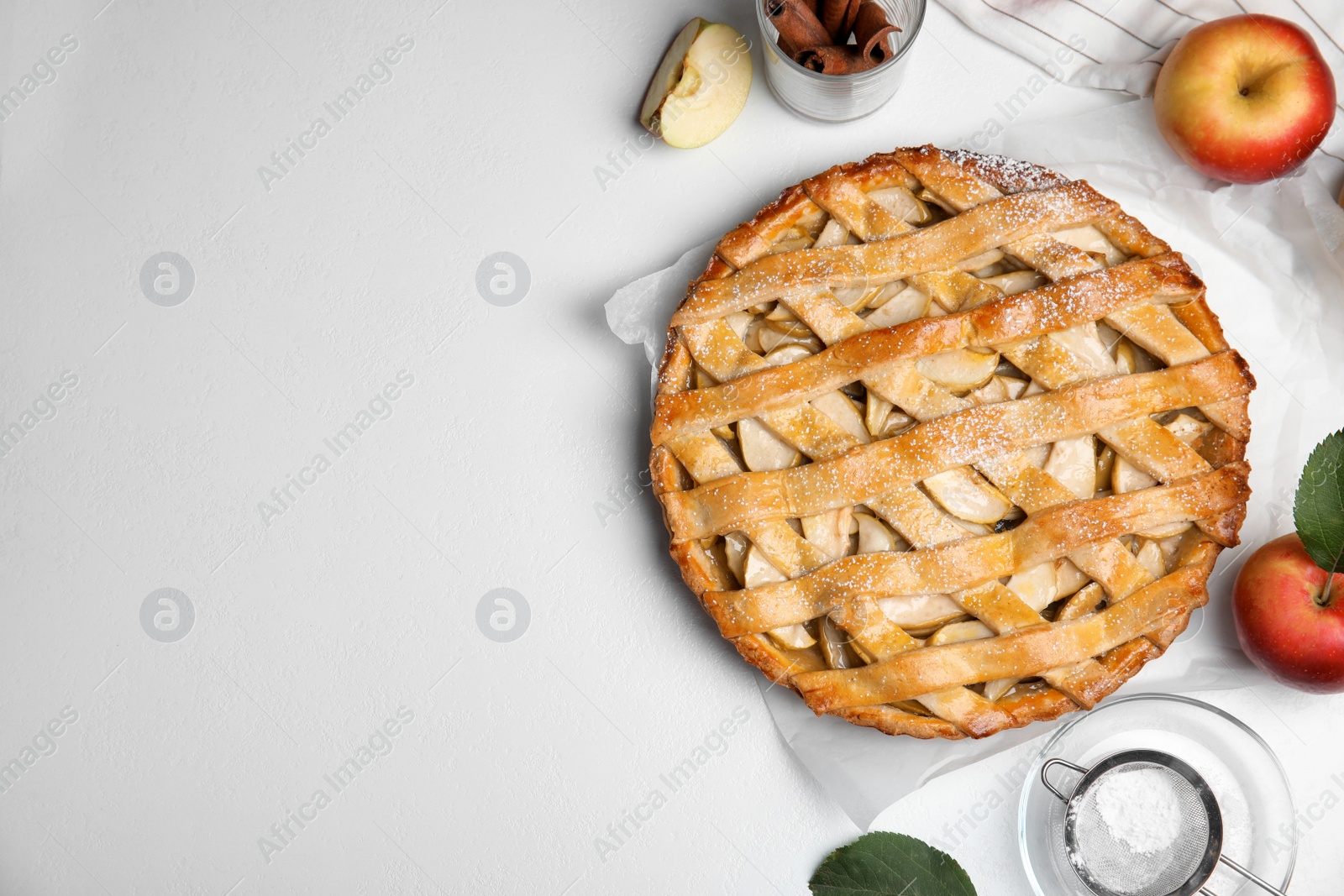 Photo of Delicious traditional apple pie on white table, flat lay. Space for text