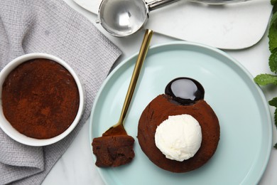 Photo of Delicious fresh fondant with hot chocolate and ice cream on white table, flat lay