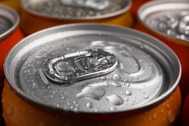 Energy drinks in wet cans, closeup. Functional beverage