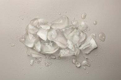 Photo of Pieces of crushed ice on grey background, top view