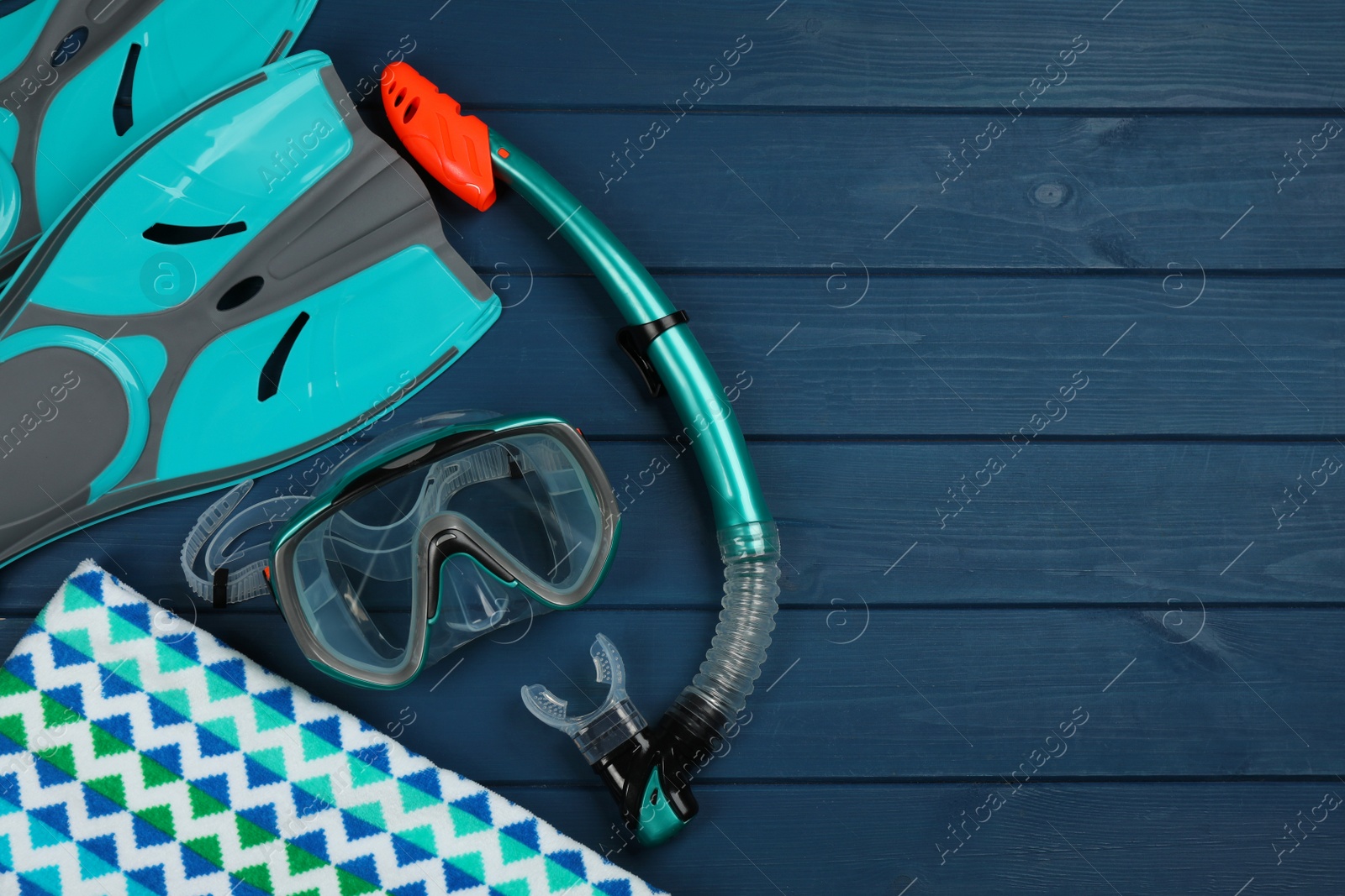 Photo of Flat lay composition with beach objects on blue wooden background, space for text
