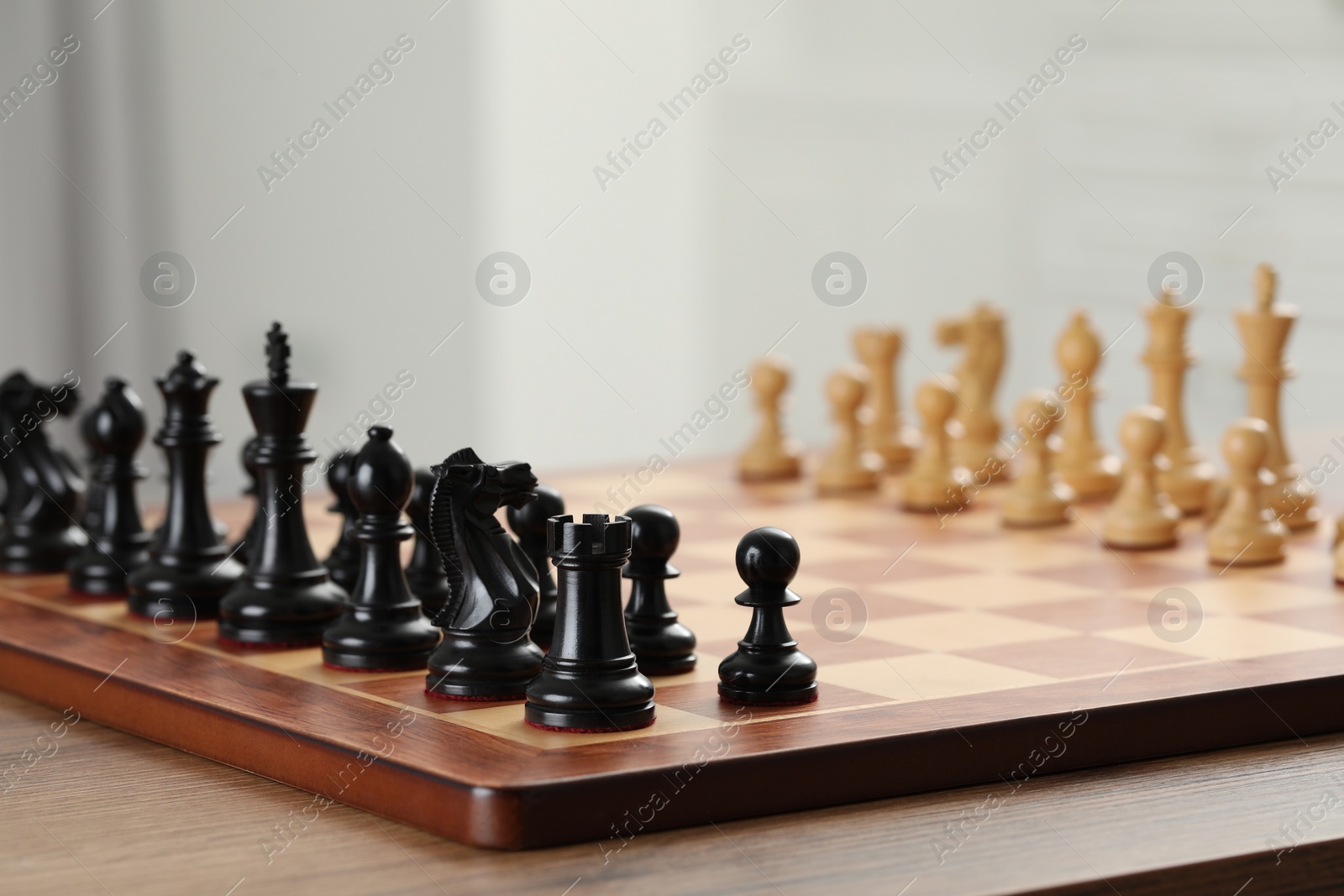 Photo of Set of chess pieces on checkerboard before game, selective focus. Space for text