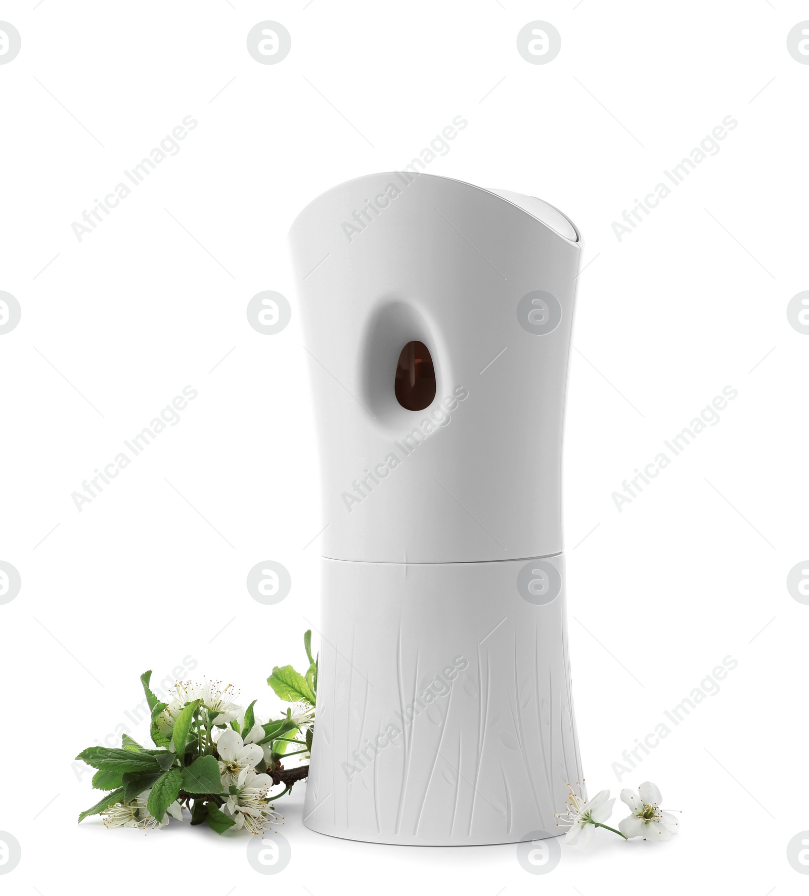 Photo of Automatic air freshener and flowers on white background