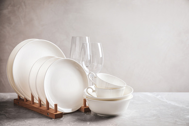 Set of clean dishware on marble table