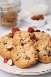 Photo of Cookies with freeze dried fruits and nuts on white table, closeup